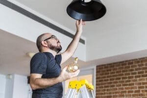man-changing-light-bulb-min man-changing-light-bulb-min