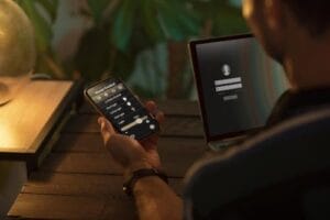 person-using-smartphone-his-automated-home-min person-using-smartphone-his-automated-home-min