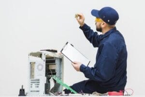 sideways-man-repairing-computer-min sideways-man-repairing-computer-min