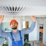 Service technician checking and repairing air condition