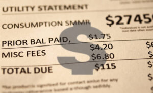 Why Knoxville Homeowners Shouldn’t Ignore a Leaky Faucet 1 Large grey dollar sign over a water bill showing financial details.