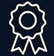 White outline icon of a rosette award ribbon on a dark background.